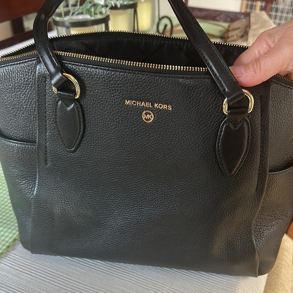 Michael Kors women’s handbag with bag feet on bottom.